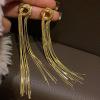 Design advanced long golden earrings, trend of season, light luxury style