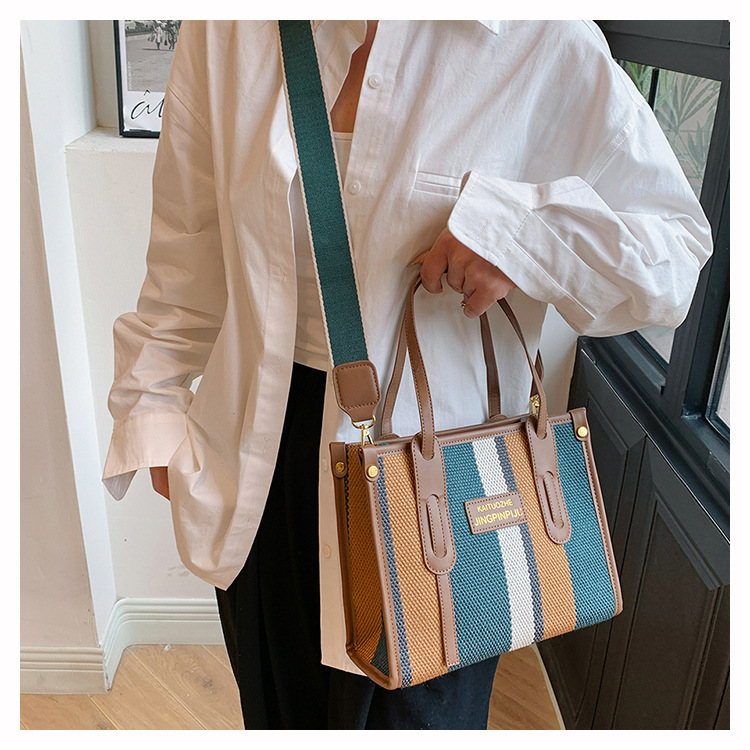 Bolso Tote portátil a rayas de color de contraste de lona para mujer 2024 nueva textura de moda transfronteriza bolso de mensajero de un solo hombro