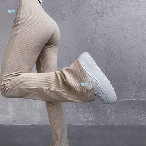 High-waist elastic long pants with a fitted, ribbed, and slightly flared casual design
