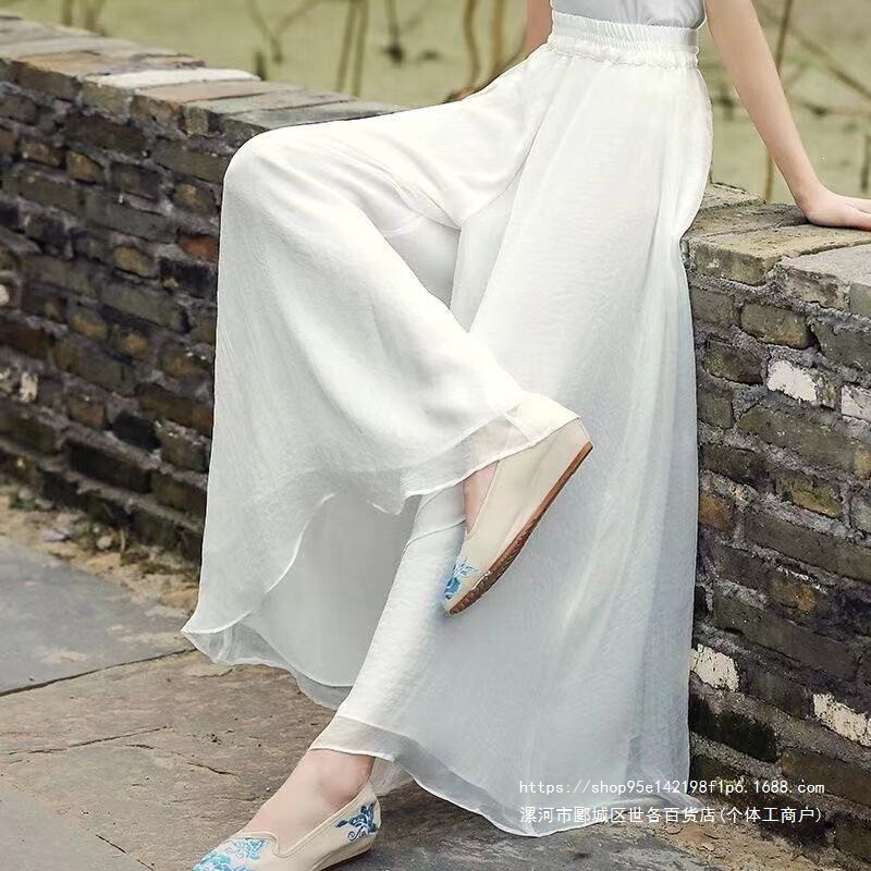 White chiffon long regular-style wide-leg pants, casual skirt-pants with a flowing drape and large hem White chiffon long regular-style wide-leg pants, casual skirt-pants with a flowing drape and large hem