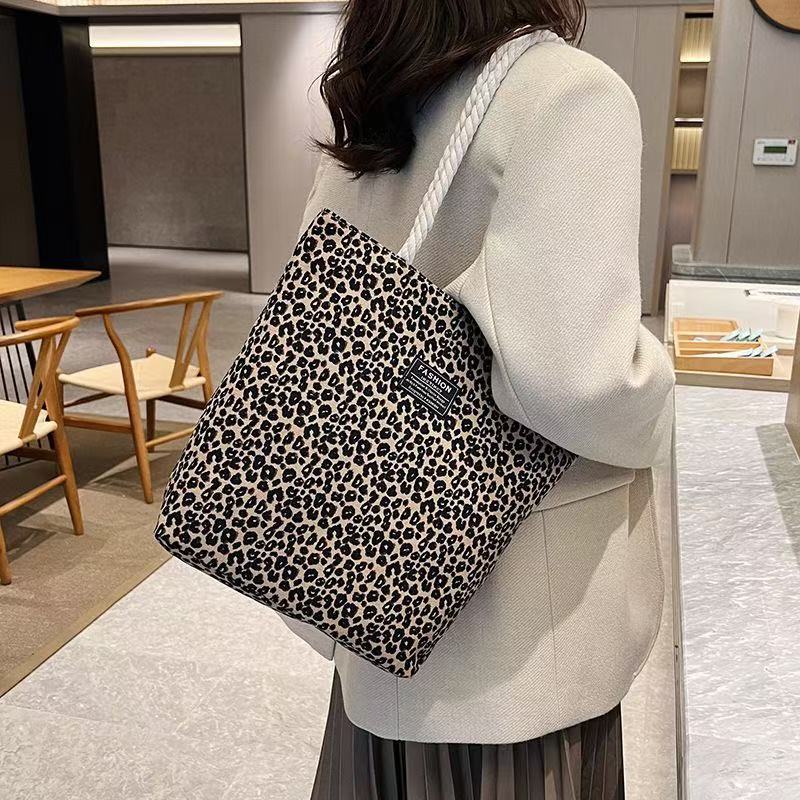 Bolso de mujer 2026 nueva impresión bolso de lona de moda leopardo coreano bolso de gran capacidad bolso de hombro de mano de compras