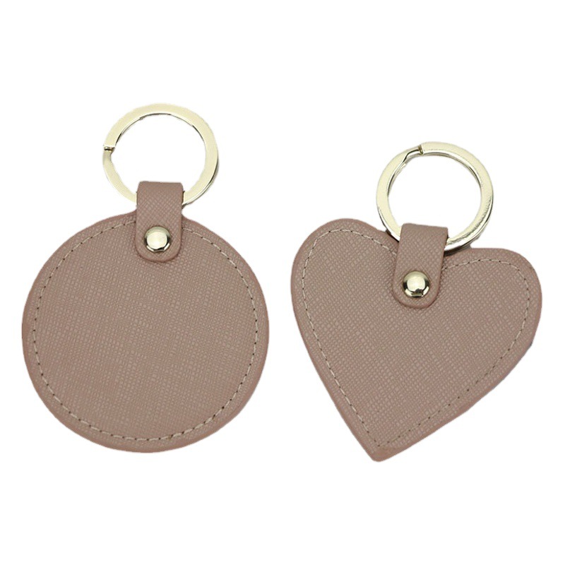 Llavero redondo de cuero genuino personalizado creativo simple colgante hombres y mujeres pequeño exquisito pequeño regalo al por mayor todo a juego