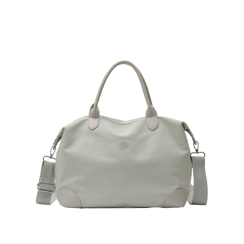 Nueva bolsa coreana para niños, bolsa de viaje ligera de gran capacidad, bolsa de mano casual simple de color sólido para niños y niñas