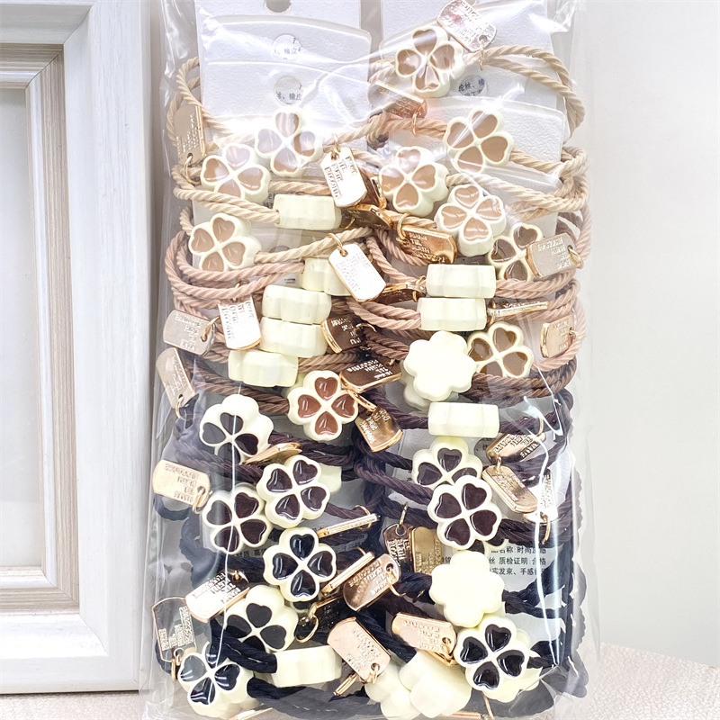 Etiqueta de estilo coreano accesorios para el cabello para niños Perla pequeña pajarita cuerda de pelo chica estudiante cabeza cuerda banda de goma dos yuanes suministro de la tienda