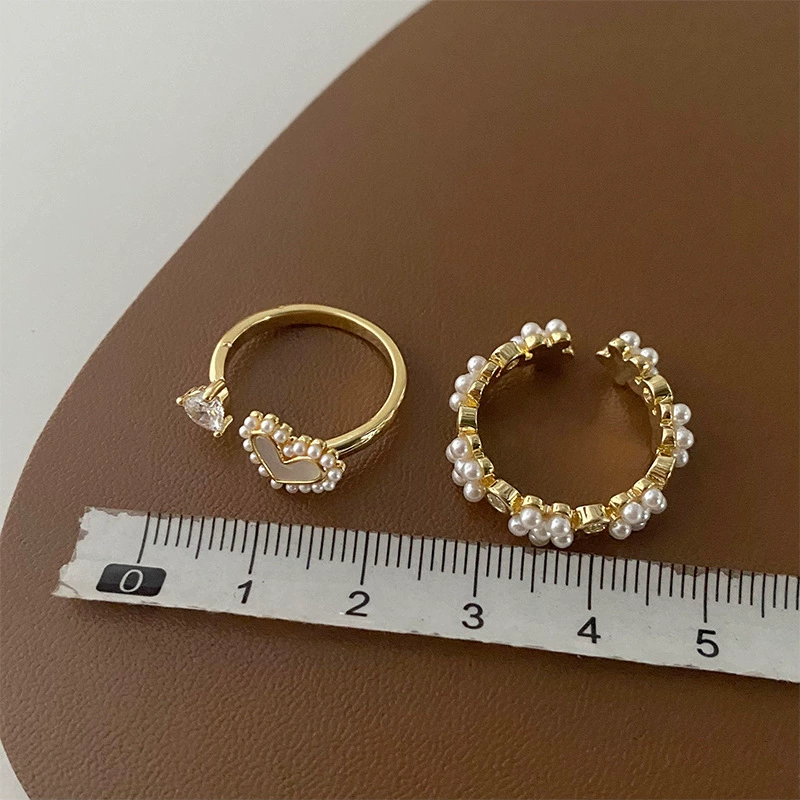 Small design retro universal ring from pearl, flowered, simple and elegant design, on index finger