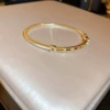 Golden bracelet with letters, letter D