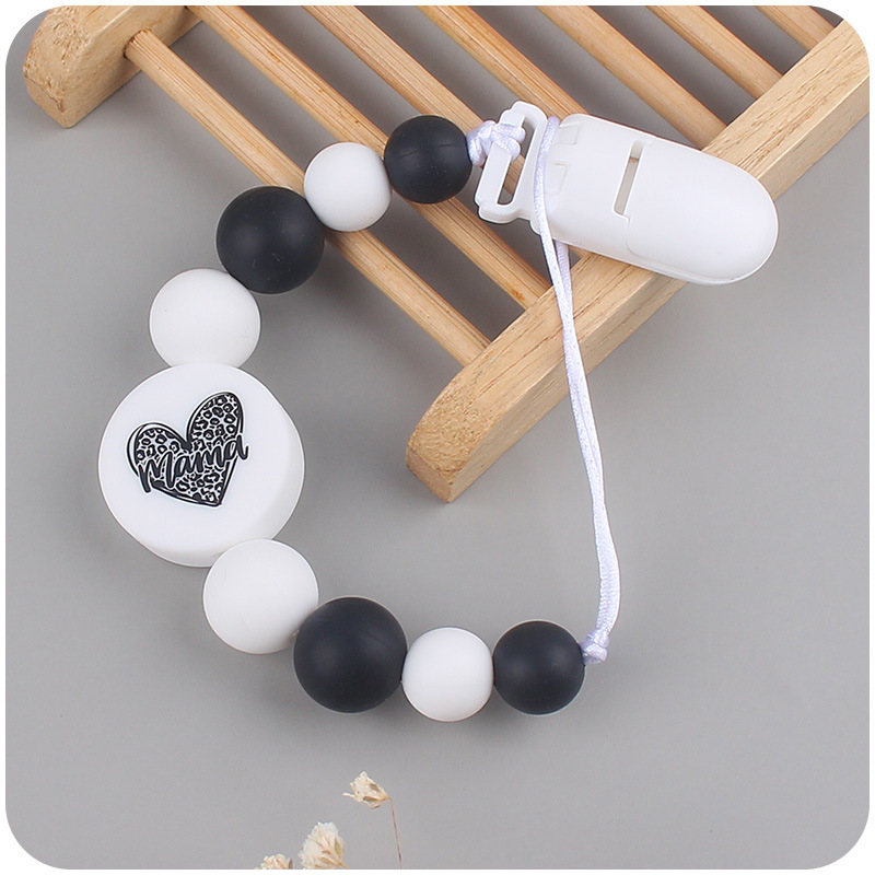 Nuevo bebé suministros de dibujos animados de impresión redonda amor creativo DIY silicona mordedura molar pezón cadena anti-caída