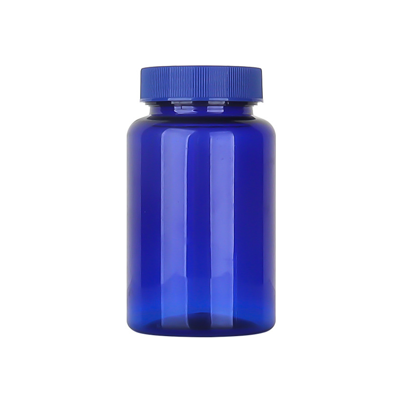 Botella de plástico azul 80–150 ml con tapa estriada, envase para suplementos o cápsulas.