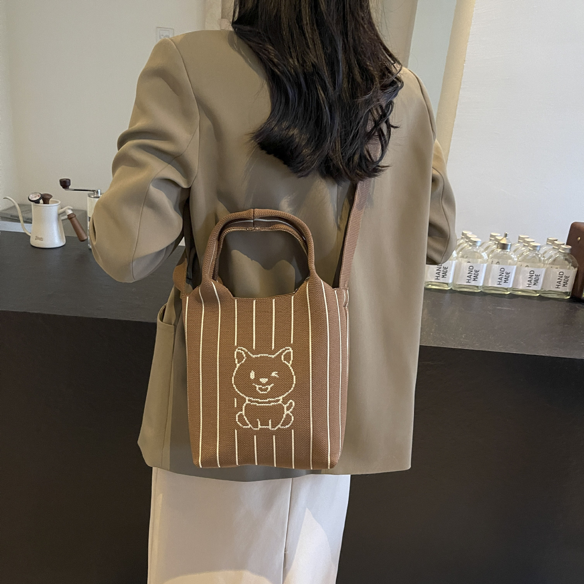 This handbag is a stylish knitted striped shopping bag. It's a popular lady's bear large-capacity tote single-shoulder bag for going out Application Scenario