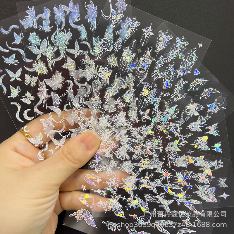 爆発的なネイルシールの上品な半透明な白い花びらの蝶のカラフルなオーロラガラスの破片には、ゴムの爪がついています|undefined