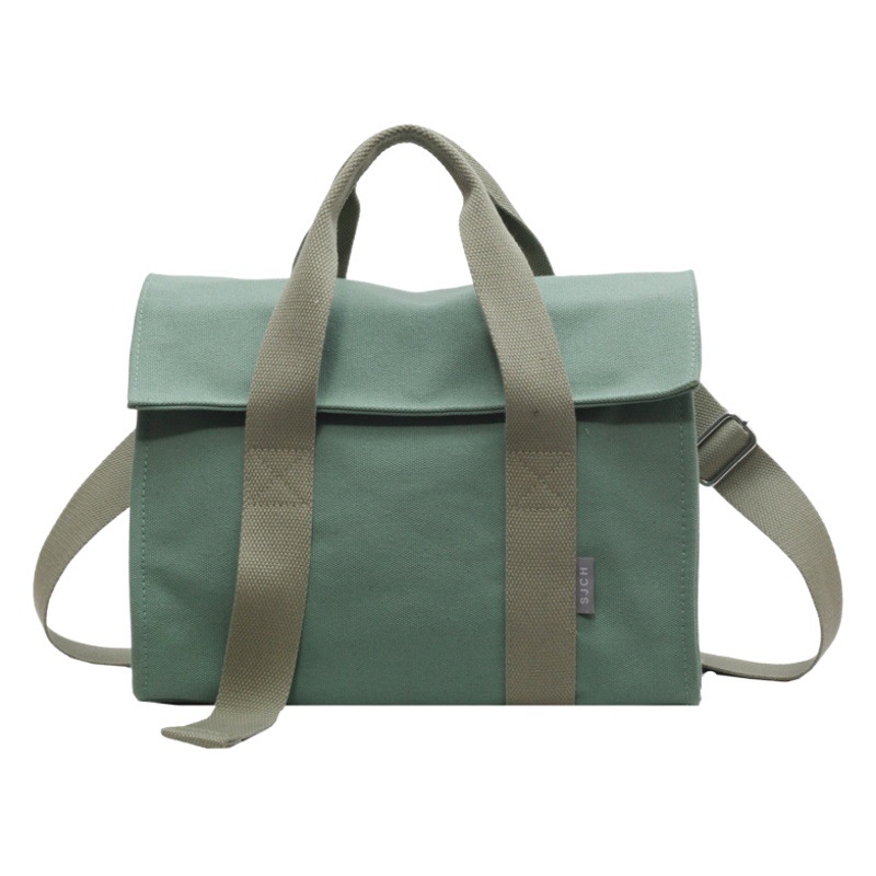 Comercio exterior bolsa de lona para las mujeres 2023 nueva moda japonesa y coreana bolsa de mano portátil nicho de alta calidad bolsa de mensajero del hombro