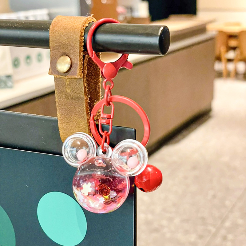 Caricatura en aceite líquido arena flotante botella mochila llavero delicado colgante accesorios accesorios máquina de muñecas pequeños regalos al por mayor