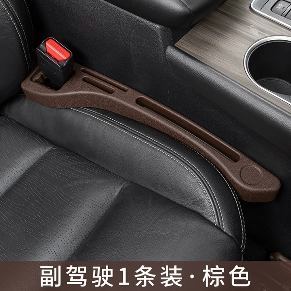 A brown opp bag is stuffed into the seat gap for the passenger
