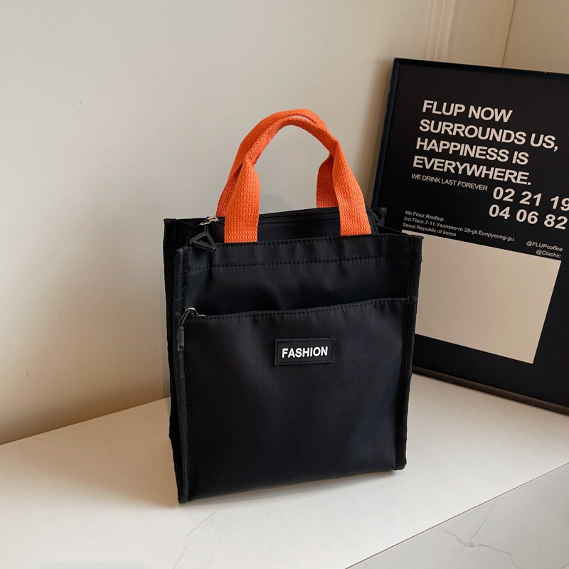 Moda coreana nueva serie de gran capacidad bolsas escolares portátiles de otoño 2024 bolsas de botellas impermeables Oxford