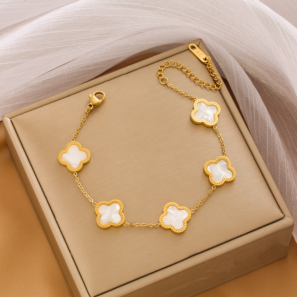 Pulsera de trébol de acero titanium vendedora caliente transfronteriza europea y americana con incrustaciones de concha pulsera colgante pulsera de diseño avanzado sin desvanecimiento al por mayor