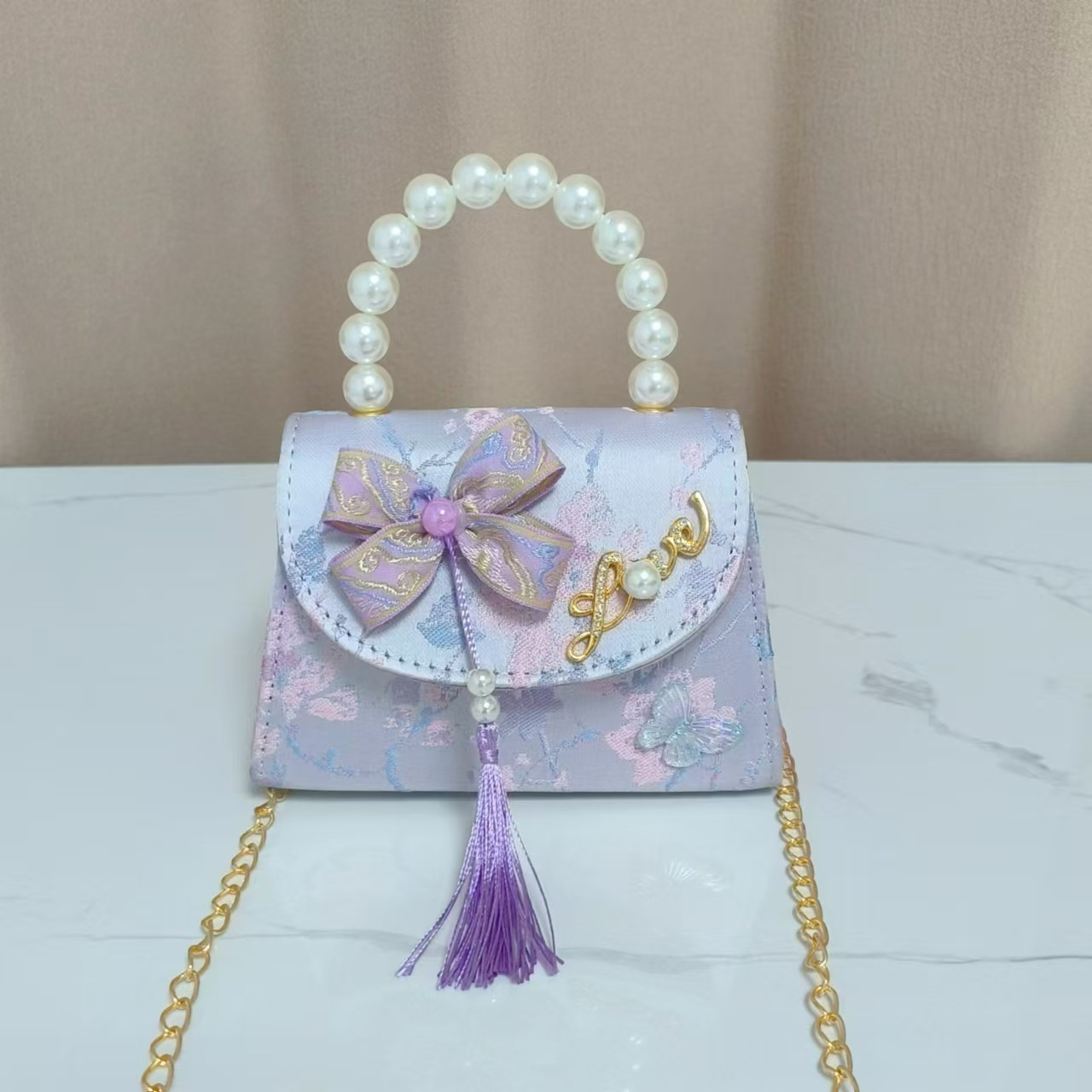 Bolsas de niños arco de estilo chino borda de niña pequeña princesa perla bolsa de cambio de mano al por mayor