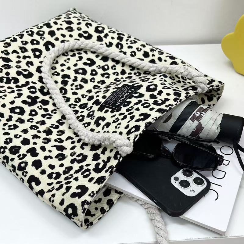 Bolso de mujer 2026 nueva impresión bolso de lona de moda leopardo coreano bolso de gran capacidad bolso de hombro de mano de compras