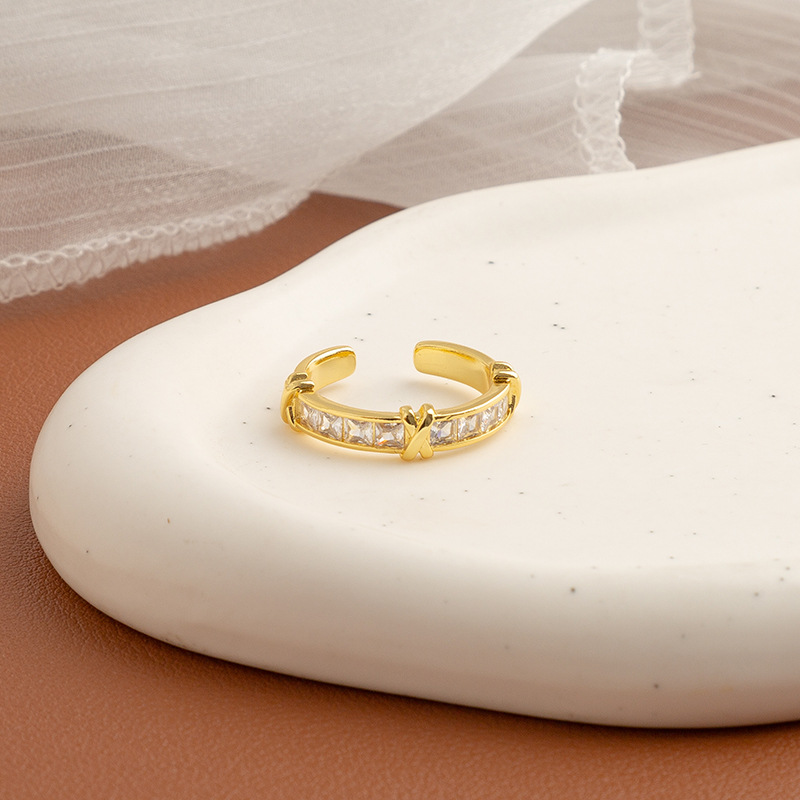 Golden ring with stone with letters with zircon