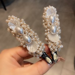 フランス風の小さい香りの風は真珠の辺をまねて女性の高級感の重工の小さい大衆の砕髪のアヒルの口を挟んで新型の髪飾りを挟みます。