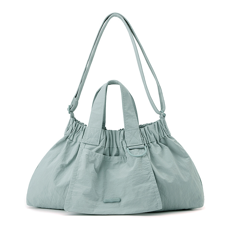 El nuevo diseño de nicho coreano del comercio exterior tiene un sentido del conocimiento de embarque a mano y una bolsa de mujer en el hombro es ligera, casual y plegable.