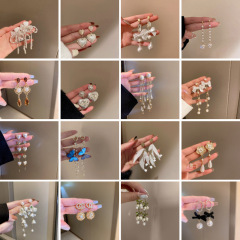 銀の針の花の蝶結びの真珠のフリンジのイヤリングの優雅な百合のイヤリングの軽い豪華な高級感のイヤリングの女性の卸売り