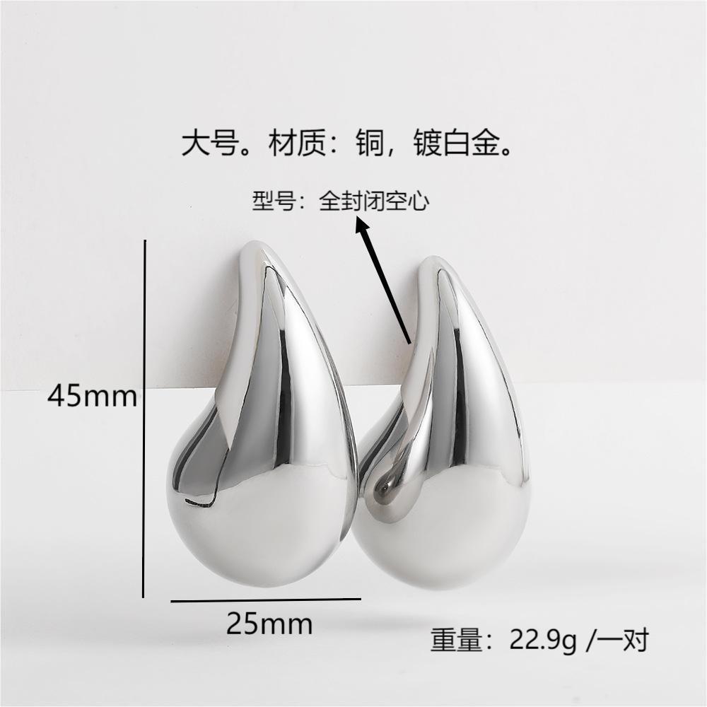 Moda europea y americana estilo caliente viento frío grande pequeña gota de agua brillante hueco 18K oro alta textura las mujeres pendientes