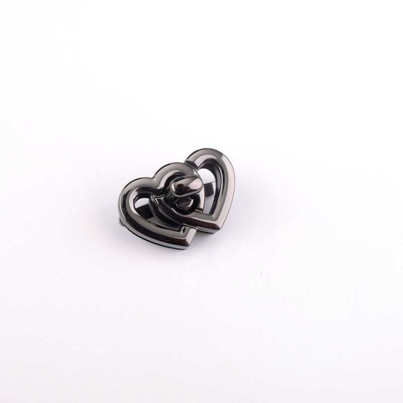 Los fabricantes suministran Bloqueo de giro de metal doble en forma de corazón bolsa de bloqueo de hardware interruptor de bloqueo de la hebilla del enchufe del bolso de las mujeres de hardware