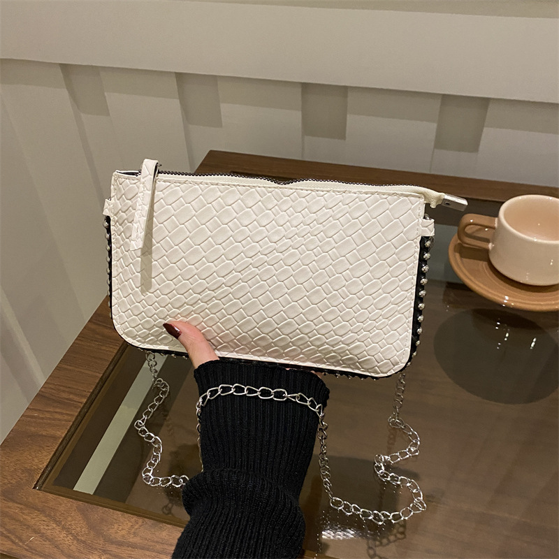 Diseño de moda bolso de hombro tejido estilo occidental color sólido 2025 nuevo temperamento retro fresco textura de axila bolso de mensajero