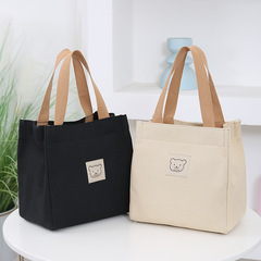 日韓厚いオックスフォードキャンバスバッグ女性ハンドバッグ弁当箱ママママママが野菜を買う布バッグを持って小包を持っている