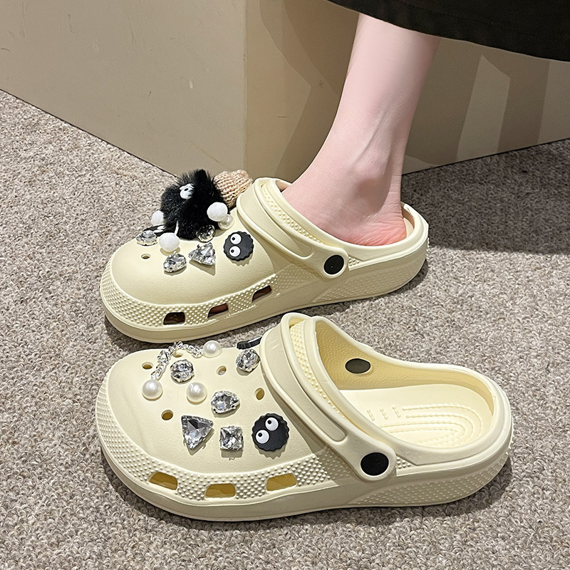 Beige Crocs-style slippers
