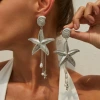 04 White K earrings (pair) 3633