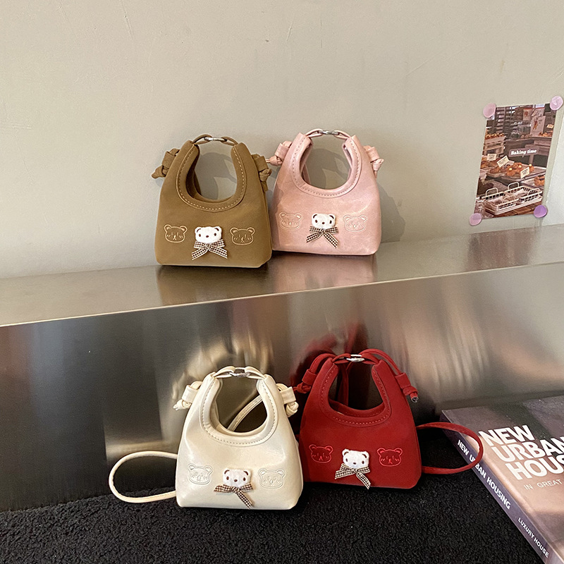 2026 nuevo bolso infantil de dibujos animados osos mini bolso de mano bebé adorable bolso de accesorios de niña pequeña