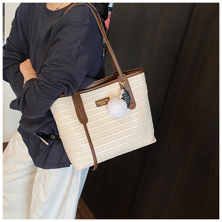 This is a new 2025 summer beach-style women's bag with a simple and versatile hand-held design. It's a single-shoulder vacation woven bag undefined