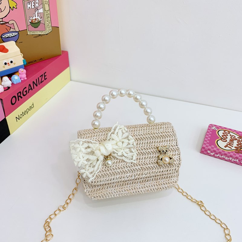 2025 verano nuevo arco de paja bolsa de perla portátil inclinada pequeña fragancia bolsa de moda para niños mochila para niñas