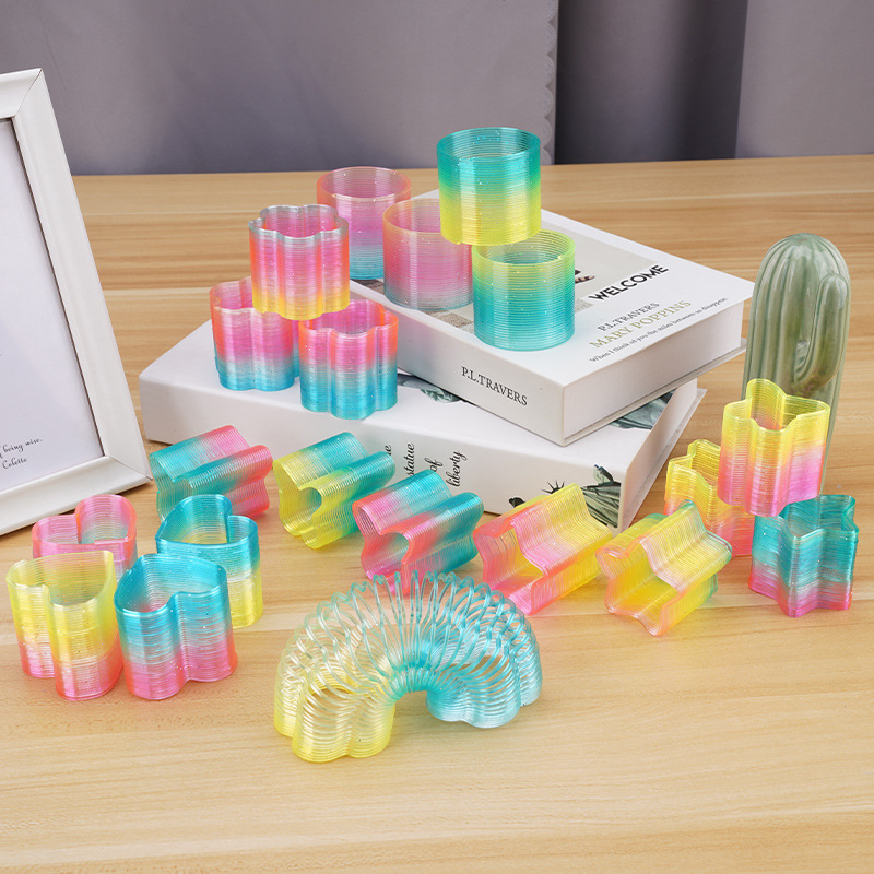 24 A box of medium shaped rainbow ring polygon spring ring students small gifts to push small toys wholesale