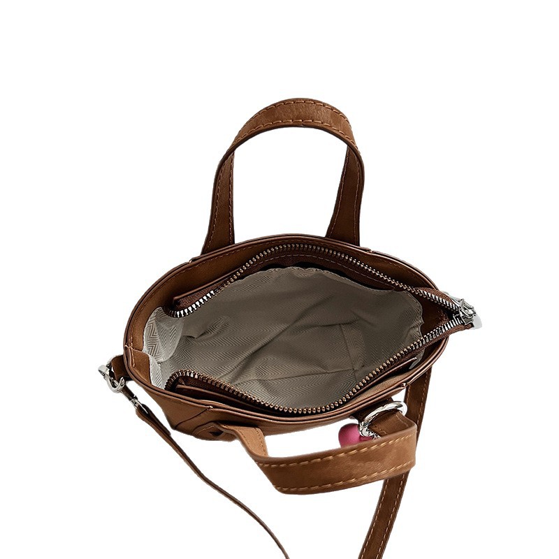 Retro nicho leopardo bolso de cubo de mujer otoño invierno 2025 nuevo tipo de bolso de cestas de verduras de mano bolsa de hombro casual mochila moda