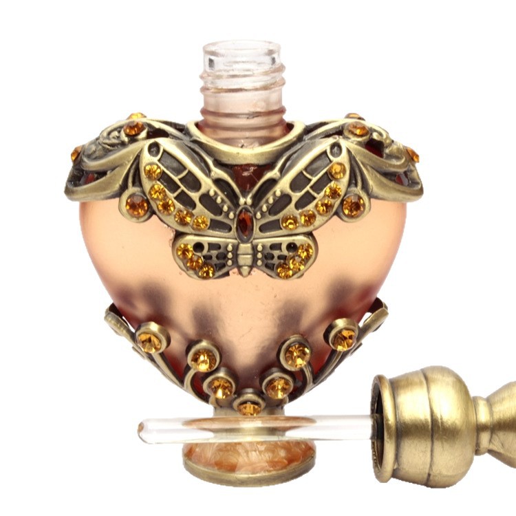 Fabricante de botellas de subenvasadas de perfume spot botella de aceite fino de 10ML al por mayor botella de perfume de Oriente Medio con incrustaciones de piedra en forma de corazón