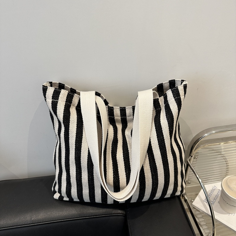 The new cross-border vertical striped commuter tote bag, hand-held shoulder bag, is fashionable and has a large capacity. It features an InS-style simple letter sail undefined