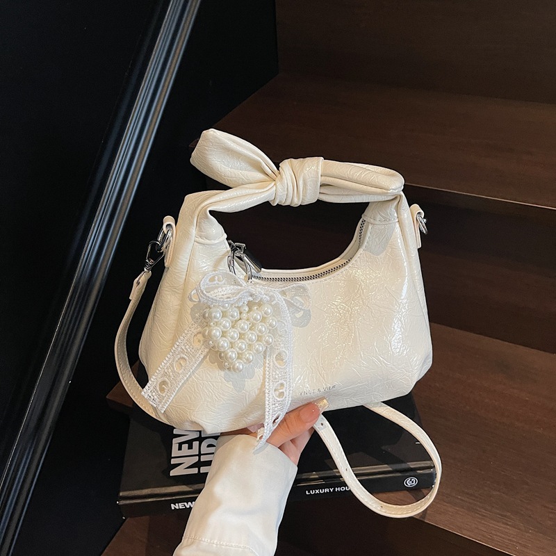 Bolso de alta calidad con textura 2025 verano nuevo estilo bolso femenino moda patrón de agarre de mano bolso de mensajero con letras de todo fósforo