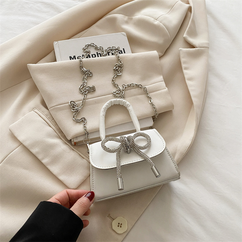 Bowknot Fashion versión coreana de estilo occidental pequeño bolso cuadrado bolso femenino 2025 verano nuevo bolso de cadena de viaje salvaje mujer