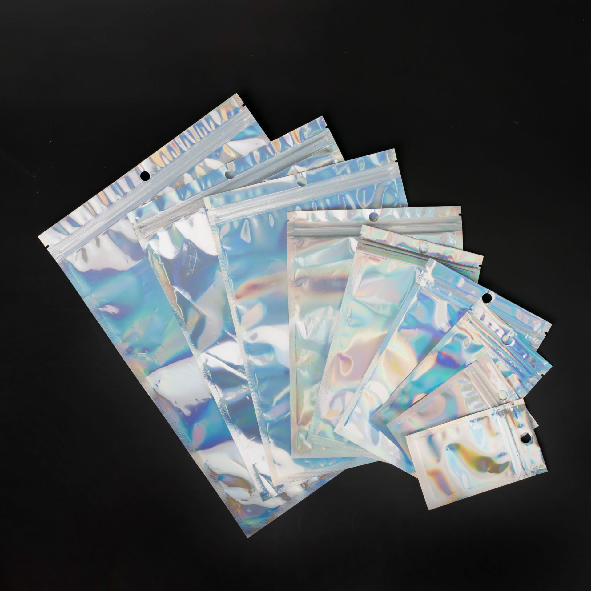 Bolsa láser Yin-Yang Bolsa autosellante Joyería Cosméticos Bolsa sellada transparente de plástico Cable de datos Joyería Bolsa de embalaje al por mayor