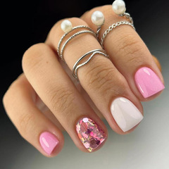 Simple solid-color pink and white glamorous nail art with glittery fragments—short, fresh, and perfect for young girls; ready-to-use nail tips in a sweet pink shade.