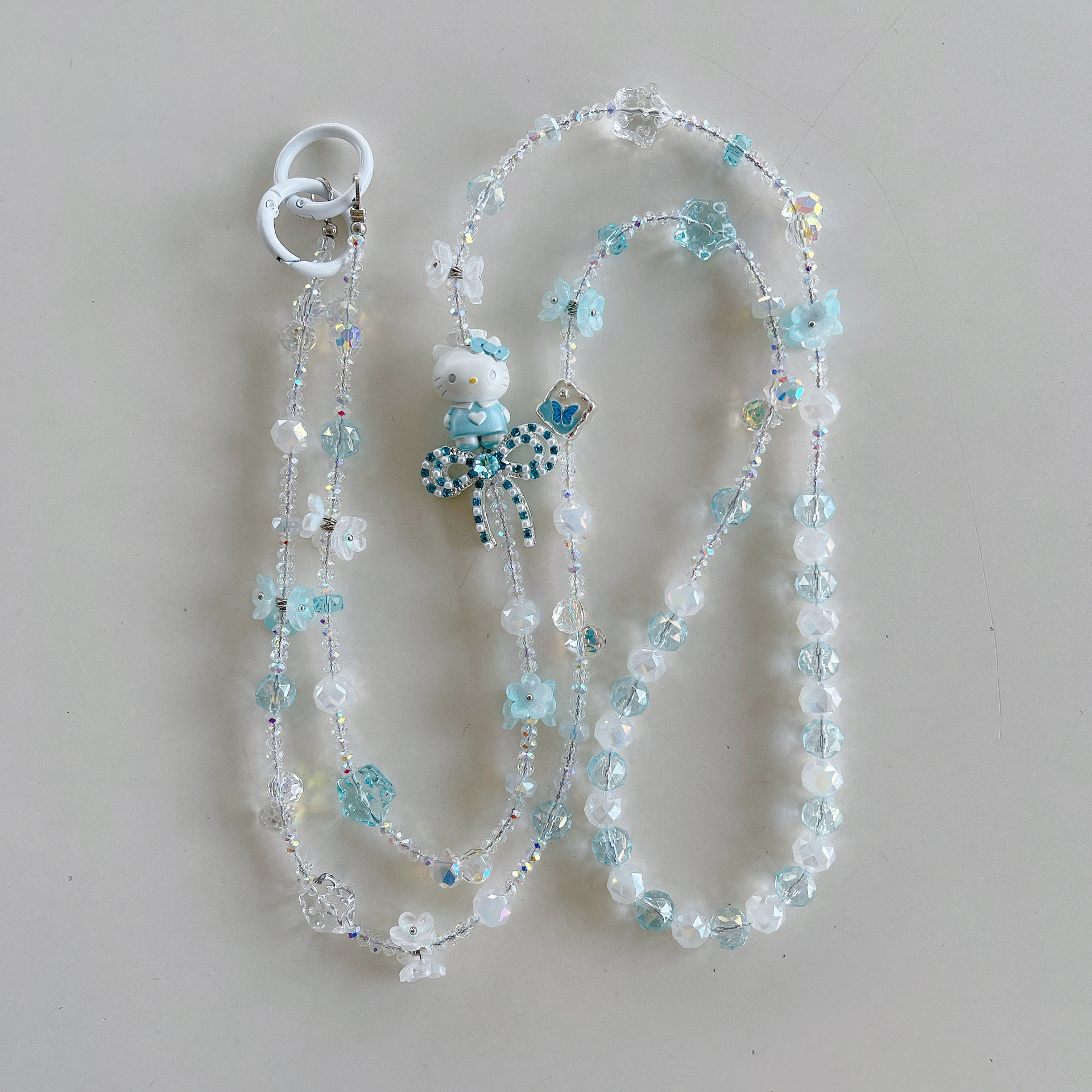 Boutique hecho a mano de alta gama para teléfono móvil cadena larga de gato KT lindo femenino cordón de teléfono móvil de moda colgante de mensajero largo