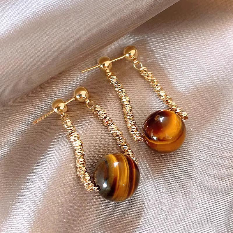 A2711 oro-mayrard curry tigre ojo piedra dos pendientes