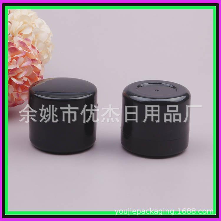 Black plastic cream jar