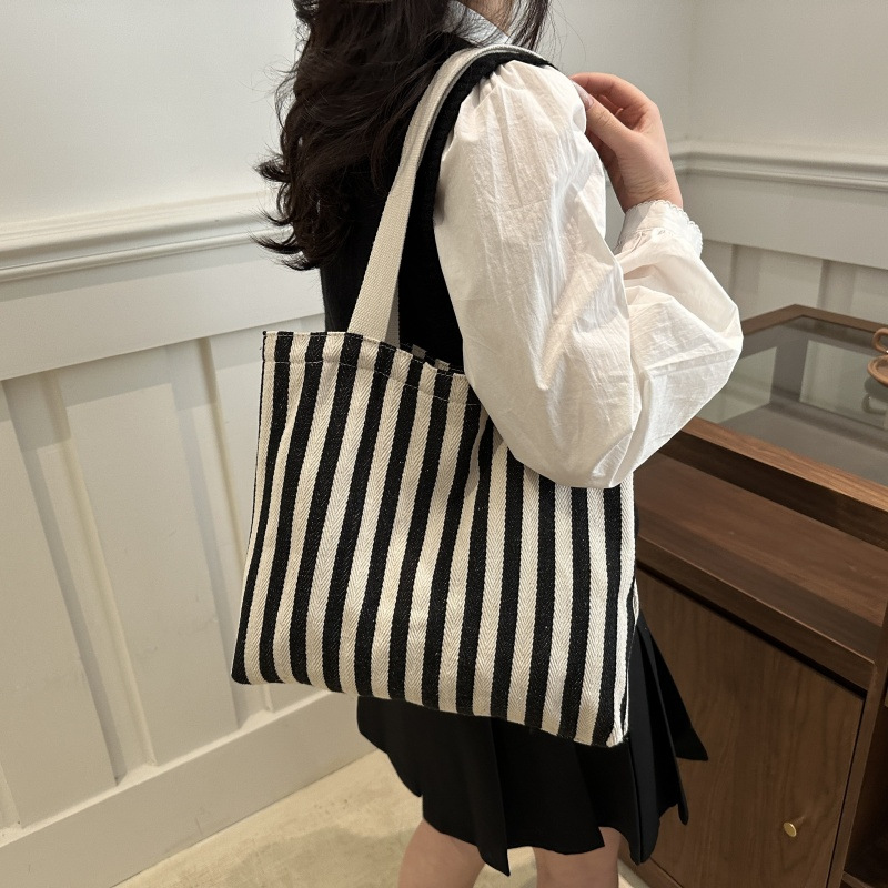 The new cross-border vertical striped commuter tote bag, hand-held shoulder bag, is fashionable and has a large capacity. It features an InS-style simple letter sail undefined