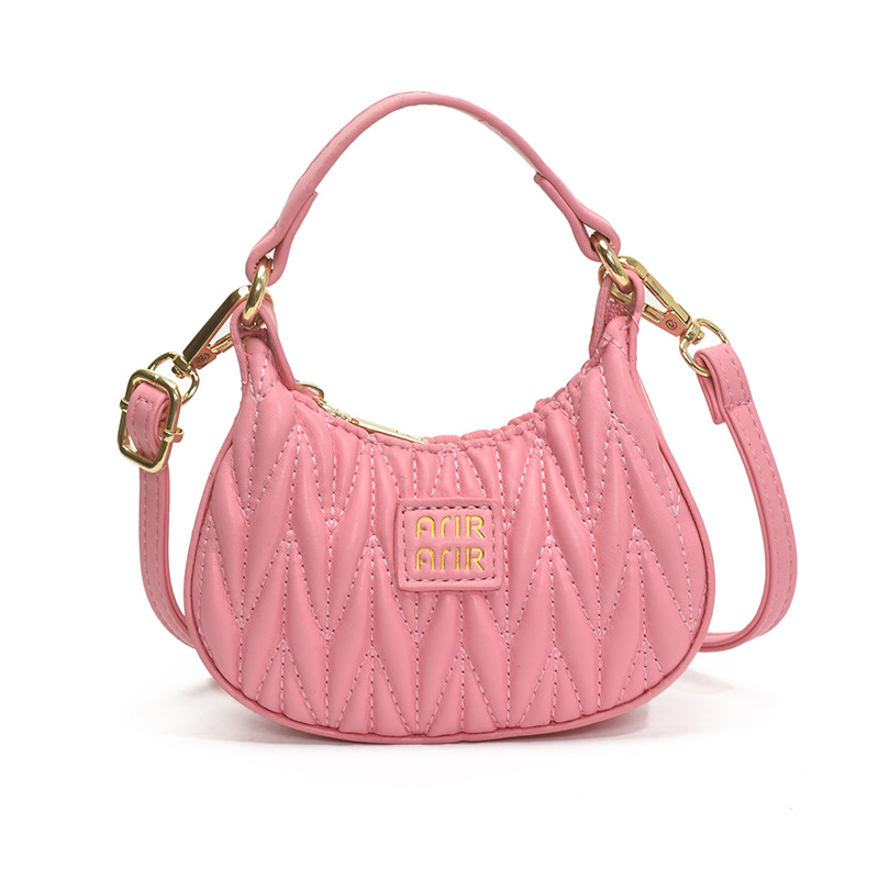 Versión coreana del bolso de hombro de niña de color sólido simple estilo occidental mini bolso de la axila portátil del bebé nuevo bolso de los niños plisado