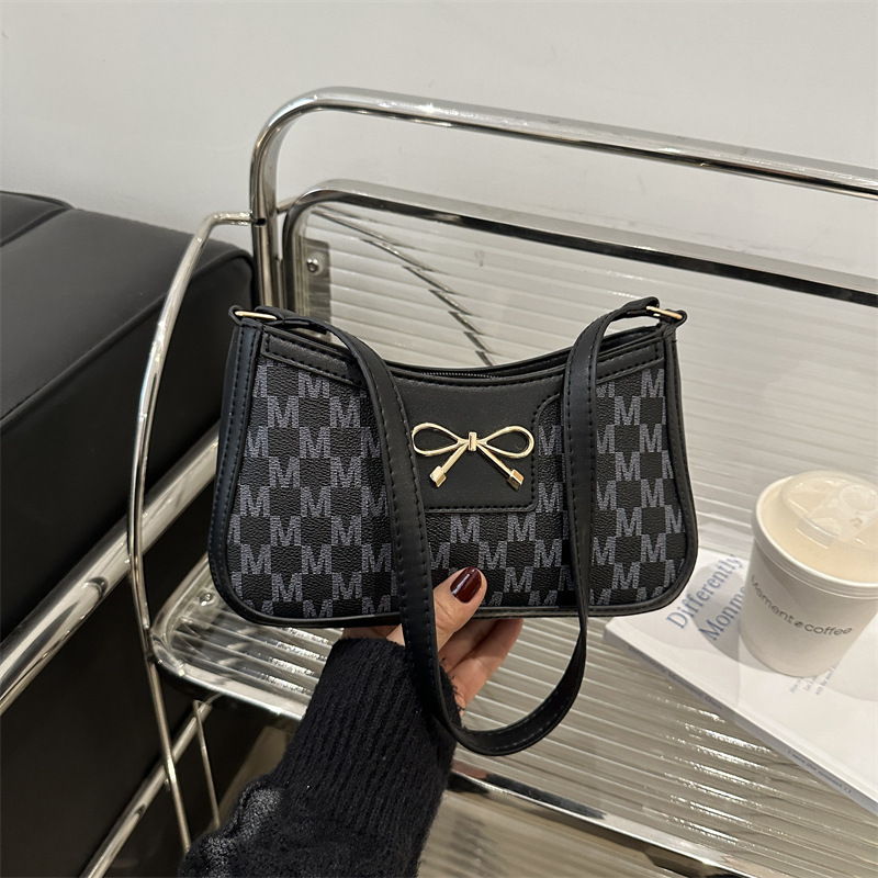 Cosmetía coreana estilo de moda textura arco de moda primavera 2025 nuevo estilo extranjero de viaje brazo bolso de hombro para mujeres