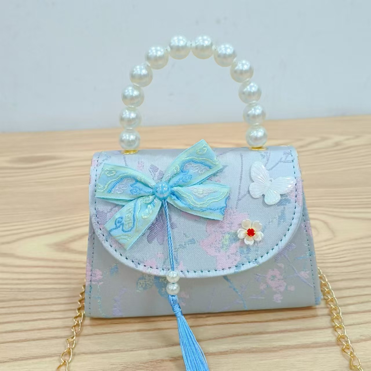 202 nuevo arco de estilo nacional bolsos para niños pequeños bolsos de moda de perlas de moda princesa bolsos de mano inclinados