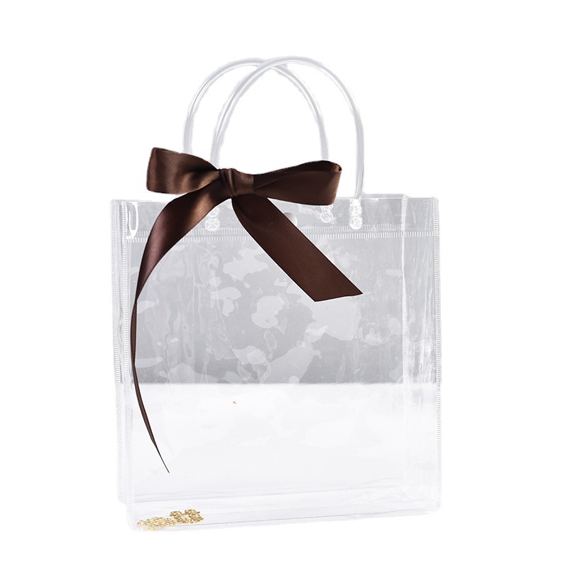 Bolsa de mano transparente de PVC, bolsa de regalo de plástico en stock, bolsa de embalaje de regalo portátil, bolsa de transporte con logo.